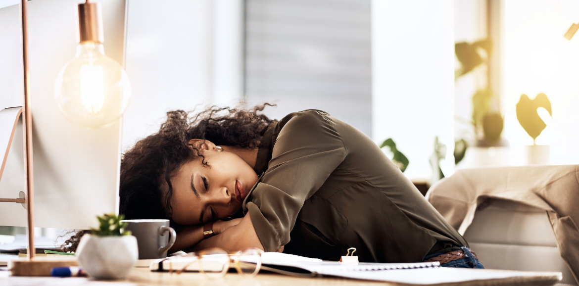 Exhausted women with her head on her desk