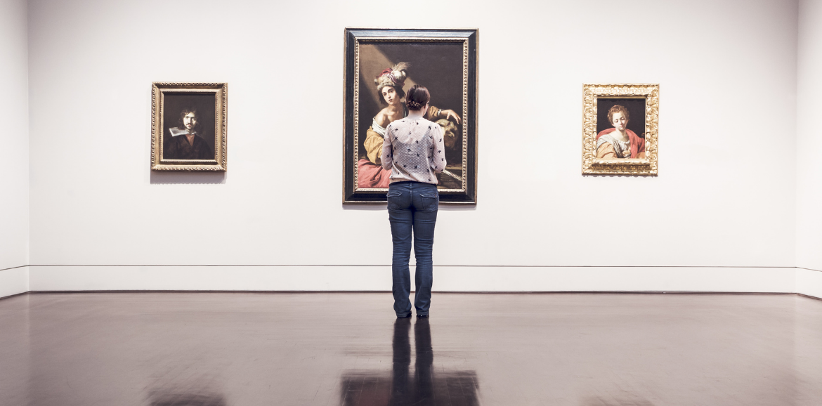 Woman standing in museum looking at art